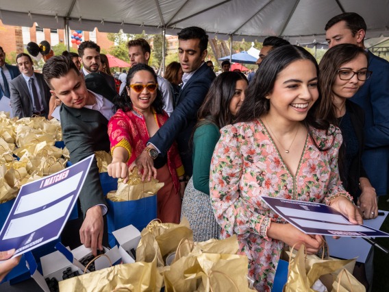 Fourth-year medical students collect gift bags before learning where they will spend the next several years in residency training programs.