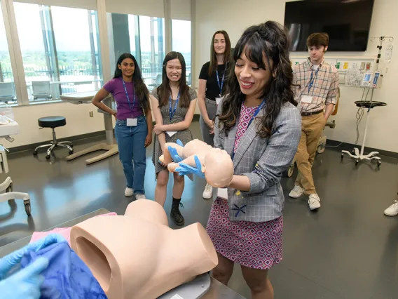 students in the birthing simulation room