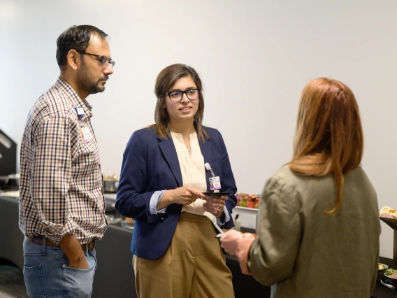 [LAMS Fellow Saher Khalid, MD (center), an internist in the Division of General Internal Medicine, Geriatrics & Palliative Medicine, with her husband, the Division of Infectious Diseases’ Talha Riaz, MD, chatting with fellow fellowship graduate Billie Bixby, MD, from the Division of Pulmonary, Allergy, Critical Care & Sleep Medicine.]