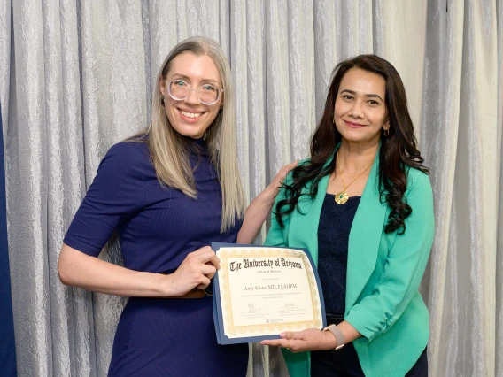 [The GGP division’s Amy Klein, MD, accepts her LAMS graduation certificate from COM-T Assistant Dean Hina Arif, MD.]