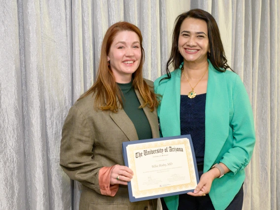 [DOM Interventional Pulmonology director Billie Bixby, MD, accepts her LAMS graduation certificate from COM-T Assistant Dean Hina Arif, MD.]