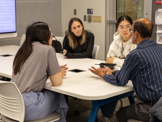 [IM Student Association members ask Puneet Shroff, MD, about his varied interests in medicine. He also completed an integrative medicine fellowship at the U of A and is a member of the college’s student-run Docapella a cappella singing group.]