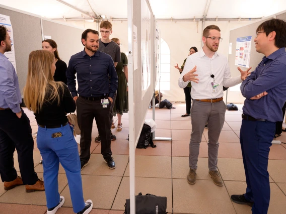 [Students, including first-year Caleb Seekins (wearing glasses on left), who’s co-president of COM-T’s Internal Medicine Student Association, chat about each other’s research posters at the COM-T 2025 Research Day poster session. Seekins’ poster is on, “Terpenes from Cannabis Sativa are Antinociceptive in a Reserpine-Induced Mouse Model of Fibromyalgia,” involving research he did working in the lab of the Department of Pharmacology’s John Streicher, PhD]