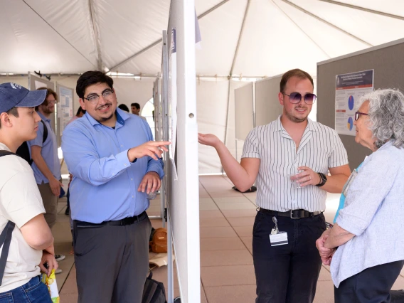 [Mindy Fain, MD, chief, Division of General Internal Medicine, Geriatrics & Palliative Medicine, chats with Daniel Benson, MEng — a PhD candidate working in the lab of the Division of Cardiology’s Steven Goldman, MD — about his poster on display April 29 at the belated Poster Session for COM-T Research Day.]