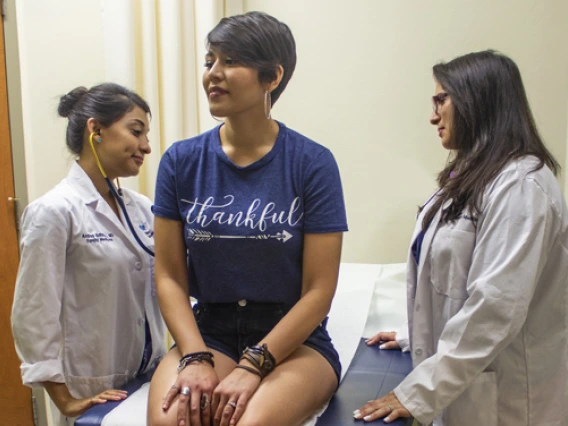 attending physician with student doctor and patient