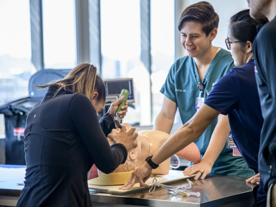 A student practices intubation on a mannequin