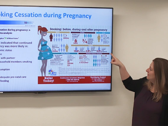 doctor explaining research poster
