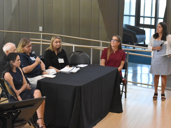 [Christine Gaul, MBA (holding microphone), Research Administration operations director, U of A Health Sciences, discusses how its staff works with investigators and the IRB to ensure that all their documentation and procedures in research meet the highest standards.]
