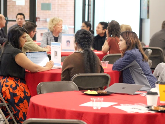 [During the Vice Chair Roundtable portion of the New Faculty Retreat, Serena Scott, MD, MBA (at left, pointing at laptop screen), speaks with Shagun Singh, MD, and Monisha Das Ireland, MD. At the table behind them are DOM vice chair of research Janet Funk, MD, speaking with Anna Morenz, MD, MPH, Susan Favour, MD, and DOM biostatistician Maryam Emami, PhD. And behind them are Joe Alpert, MD, vice chair of faculty promotions & appointments.]
