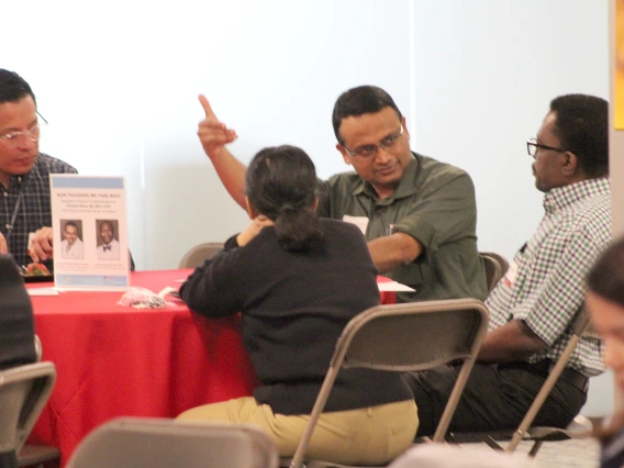 [Bijin Thajudeen, MD, DOM vice chair of community engagement & partnerships, gestures as he speaks to James Doe, MD, a clinical assistant professor in the Division of General Internal Medicine, Geriatrics & Palliative Medicine.]