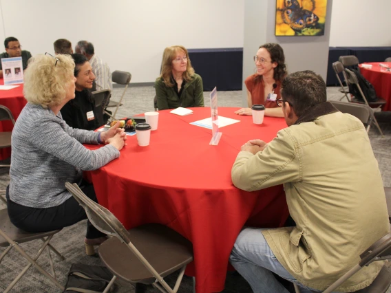 [From left, DOM vice chair of research Janet Funk, MD, and DOM biostatistician Maryam Emami, PhD, speaking with Susan Favour, MD,  Anna Morenz, MD, MPH –  with the Division of General Internal Medicine, Geriatrics & Palliative Medicine – and John Ireland, DO.]