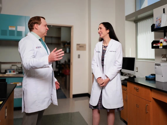 [Steffan Nawrocki, PhD (left), and Jennifer Carew, PhD, talk in their lab in the University of Arizona Cancer Center. Several pre- and post-doctoral students at the center also were co-authors of the paper based on their study that appeared in Cancer Letters.]