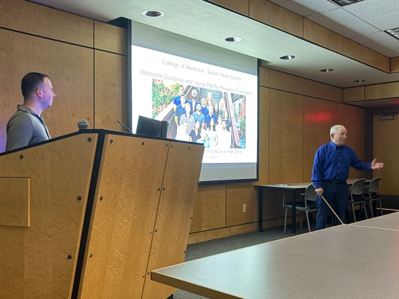 [Steve Goldman, MD (right), welcomes the board of directors of the Pfeiffer Research Foundation to the Sarver Heart Center on Oct. 22, 2025, for a tour of his lab and review of student research projects under way in his U of A College of Medicine – Tucson lab.]