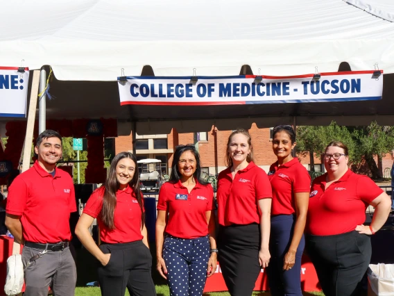 Comprehensived Education Center employees posing in front of College of Medicine – Tucson sign