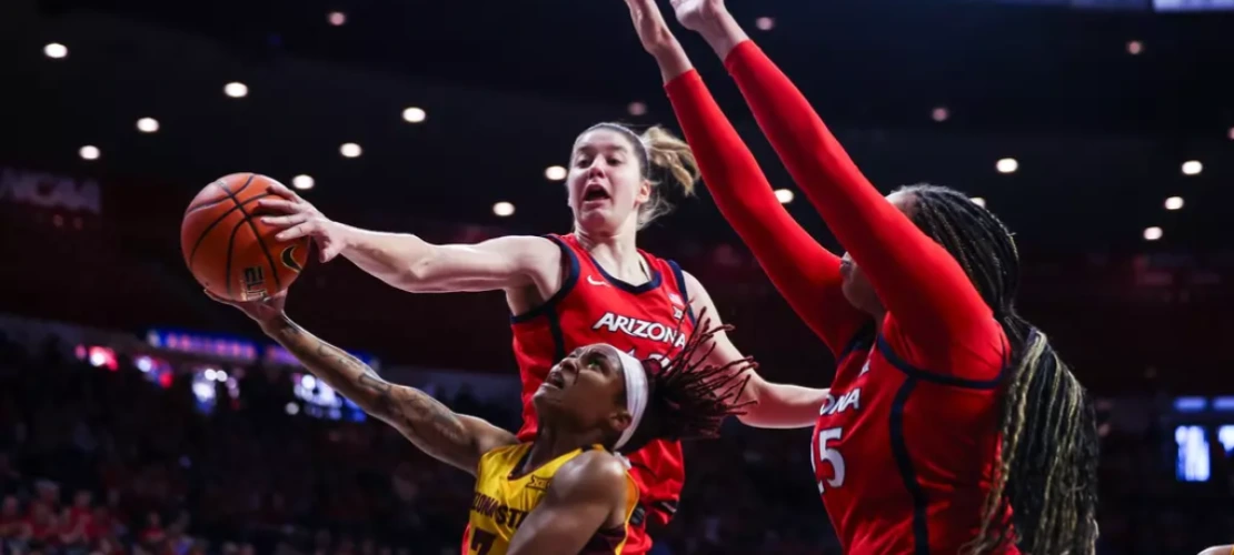 U of A’s Mailen Rolf (#13) and Breya Cunningham (#25) block the shot of an ASU player at the Feb. 8, 2025 Wear Red for Heart Health game at McKale Center.