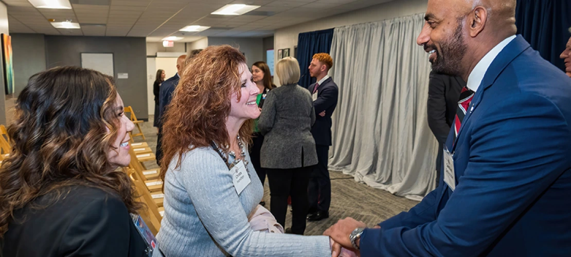 Cellular and Molecular Medicine department chair Sakthivel Sadayappan, PhD, shakes hands with Division of Cardiology’s Christa Hamilton (shaking hands) and Mia Gonzales.