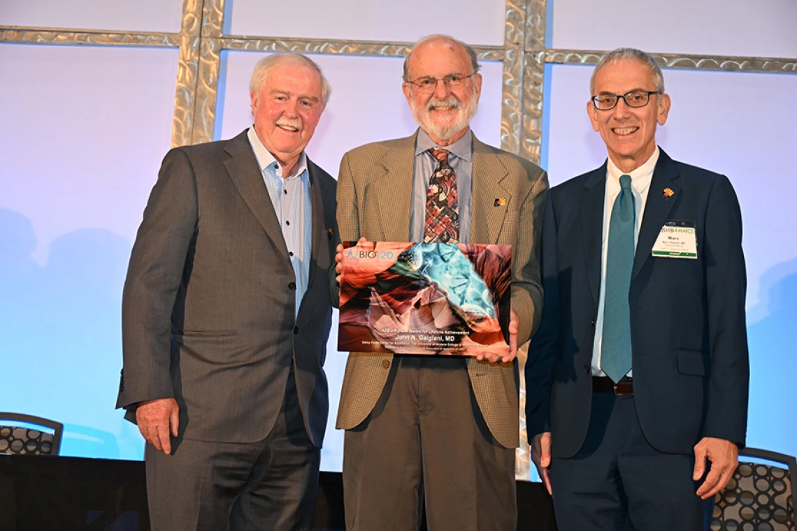 Tom Grogan, MD, a UArizona Pathology professor emeritus and Ventana Medical Systems founder, John Galgiani, MD, founder of the Valley Fever Center for Excellence (holding AZBio Pioneer Award), and the Sarver Heart Center’s Marvin Slepian, MD, pose for a photo. Both Drs. Grogan and Slepian are prior winners of the award.