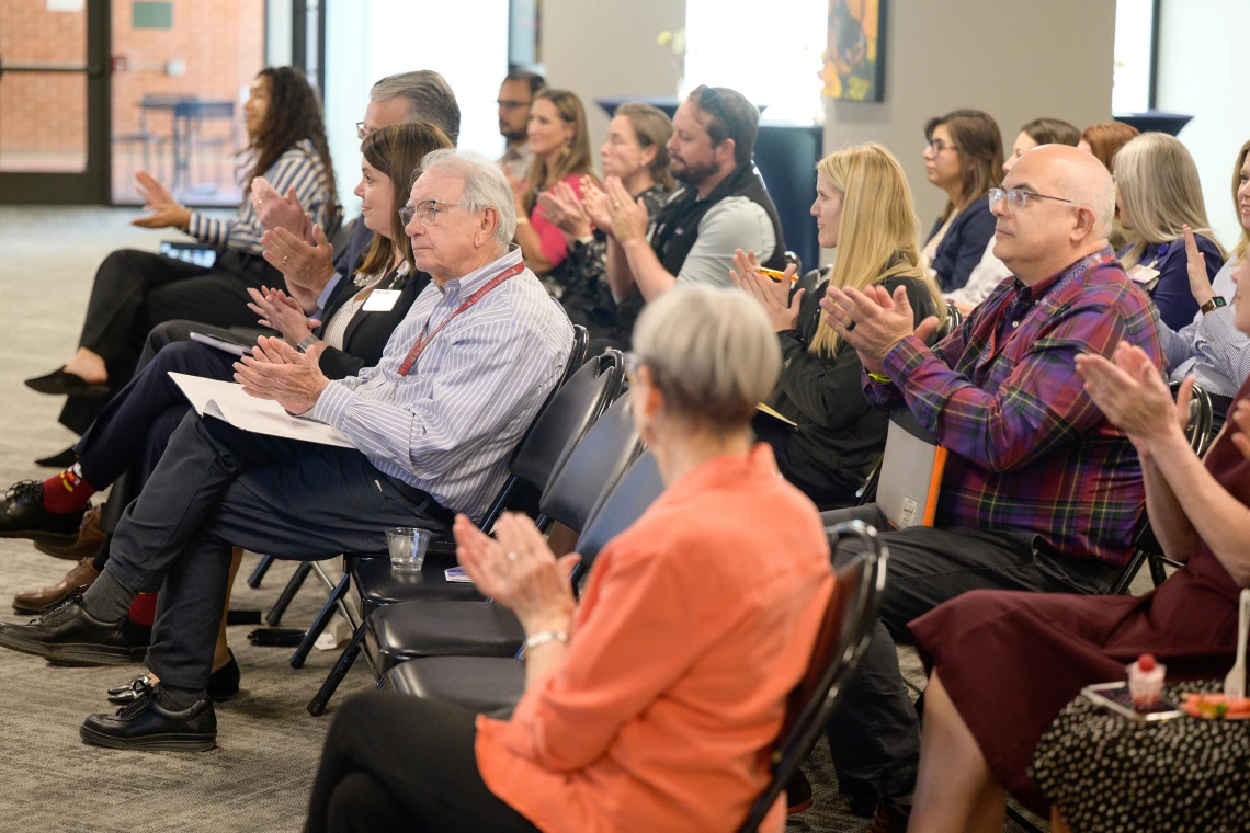 [Applauding from the audience from the DOM, see (from right in second row) the Pulmonary division’s James Knepler, MD, incoming 2025-26 LAMS Fellow Jennifer Plitt, MD, a palliative medicine specialist in the GGP division, and GGP’s Kris Abbate, MD, whose wife Michelle was a 2024-25 LAMS Fellowship graduate.]