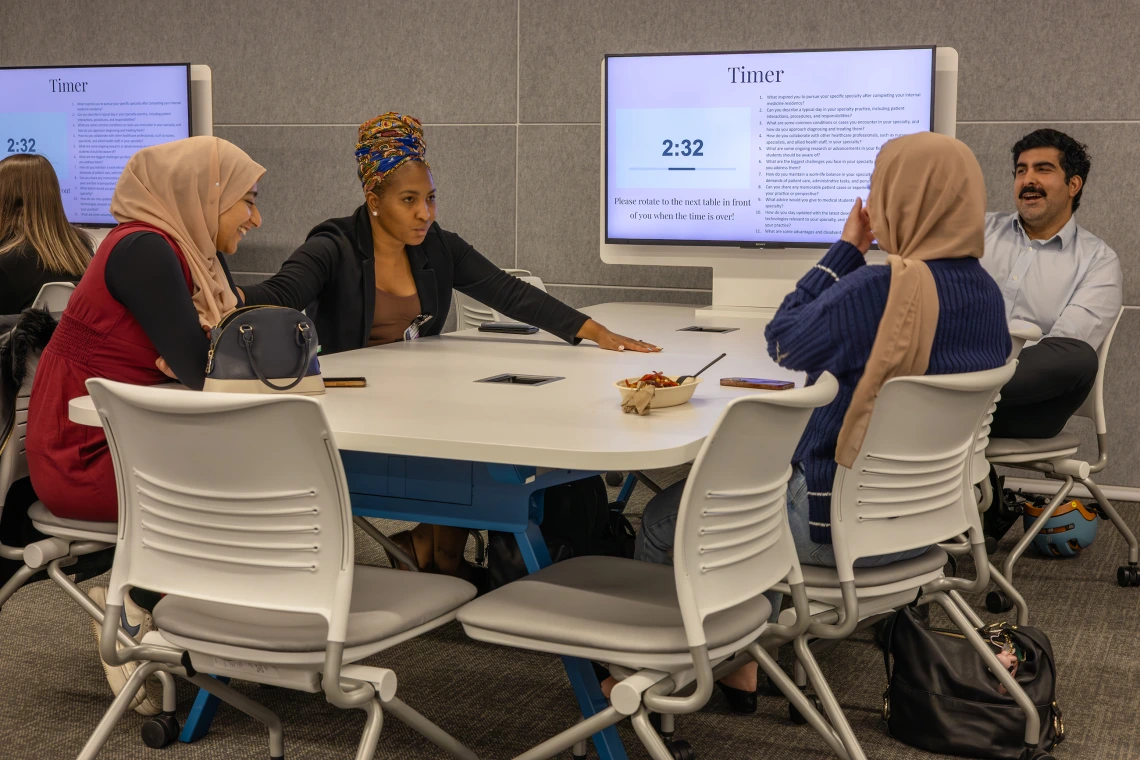 [Saman Nematollhi, MD (right), laughs at comments by Monica Hinestroza Jordan, MD (center), who talks about going to medical school in Pereira, Colombia, her hometown, and working with a mobile health unit of the Colombian Red Cross before coming to the USA for her residency and fellowship training. ]