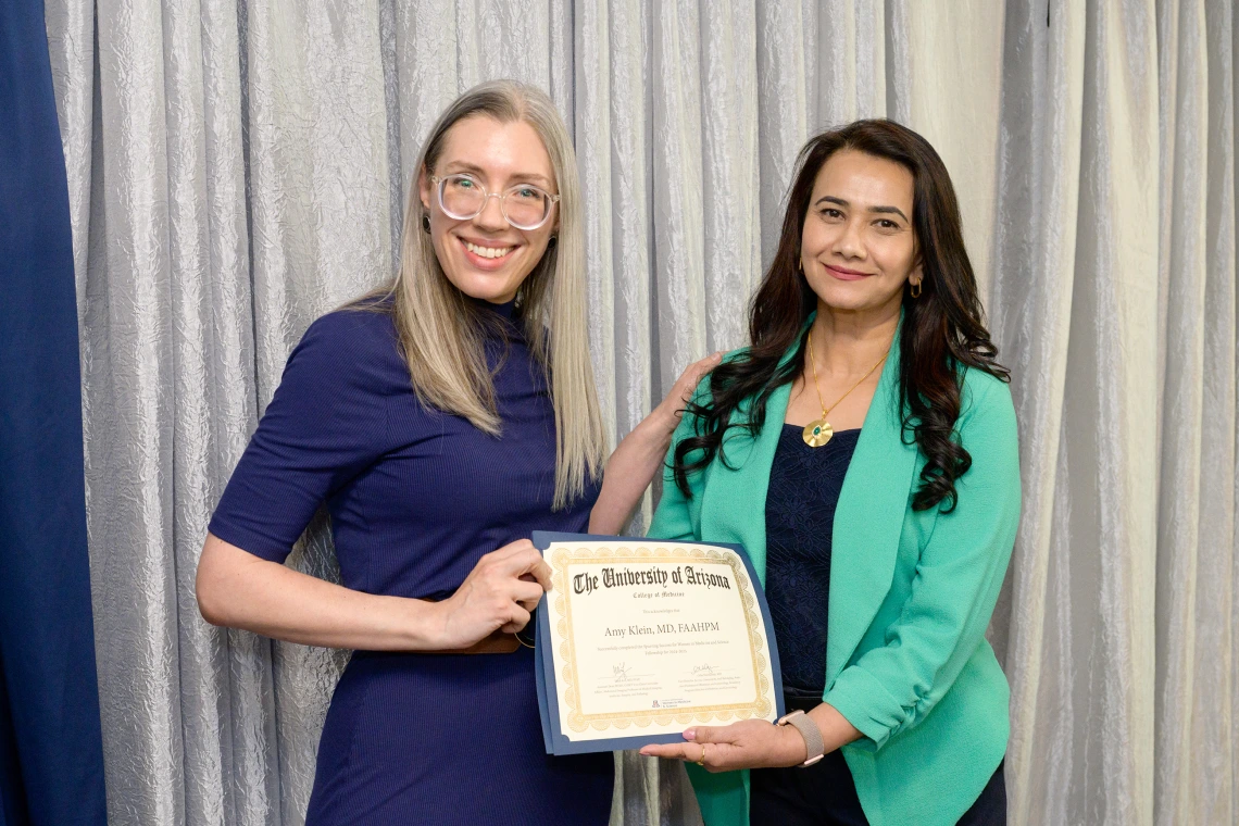 [The GGP division’s Amy Klein, MD, accepts her LAMS graduation certificate from COM-T Assistant Dean Hina Arif, MD.]