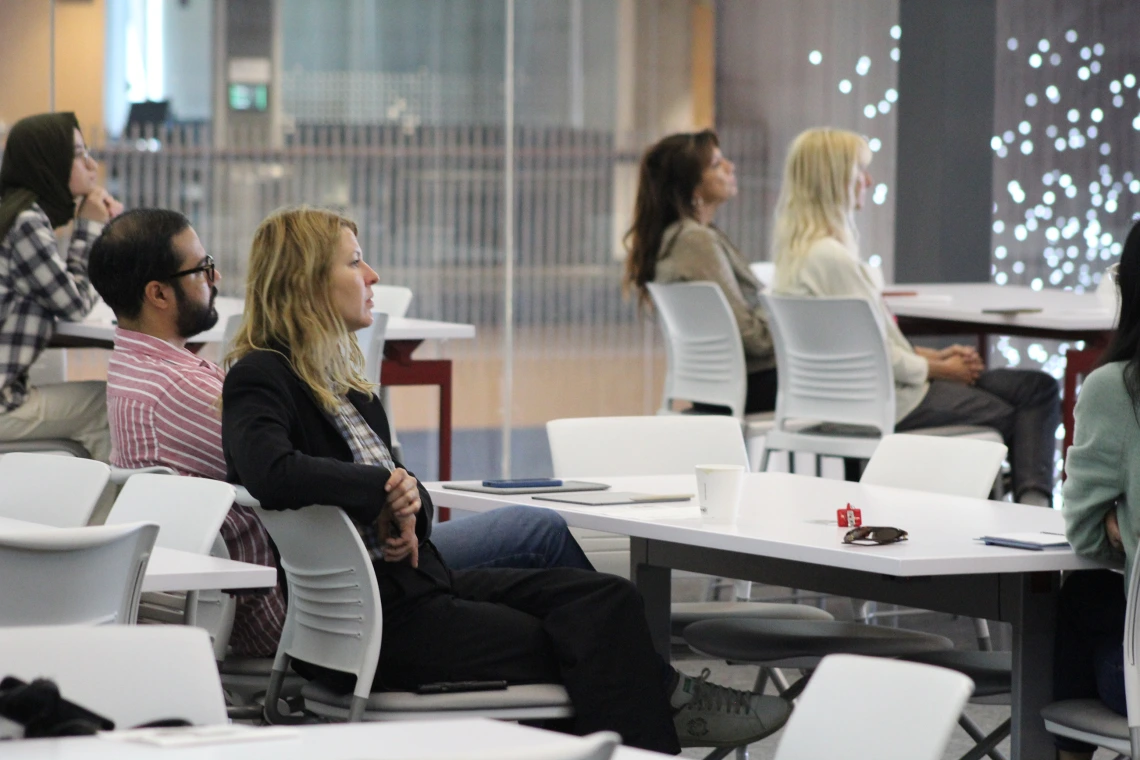 [The DOM’s Francesca Vitali, PhD, an assistant professor of medicine and neurology and Center for Innovation in Brain Science member, listens while students present on research about brain health in HSIB 306.]