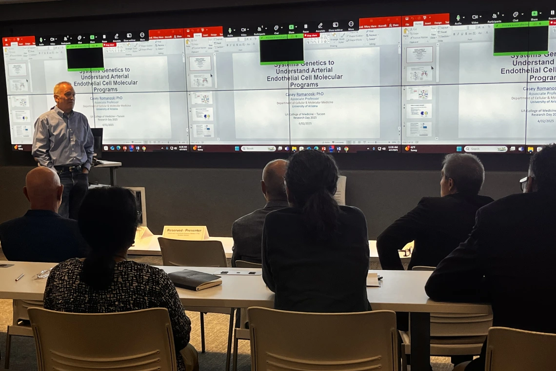 [Luke Szweda, PhD, answers a question from Hossein Ardehali, MD, PhD, about his presentation on genetics in arterial cell molecular processes during the Cardiovascular Health Breakout Session. Both are Division of Cardiology faculty and Sarver Heart Center members.]
