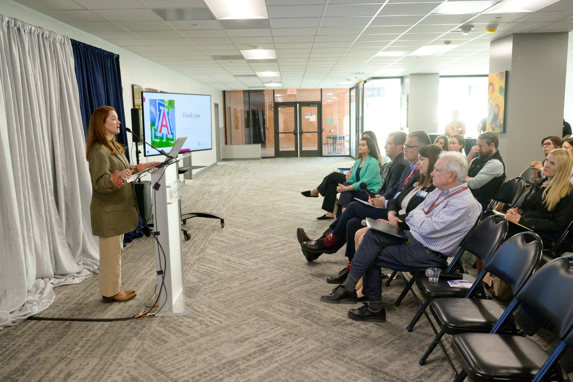 [The audience at the LAMS Fellowship graduation event in the COM-T Social Hall listen raptly to DOM Interventional Pulmonology director Billie Bixby, MD, presenting on her Leadership Experience Project.]