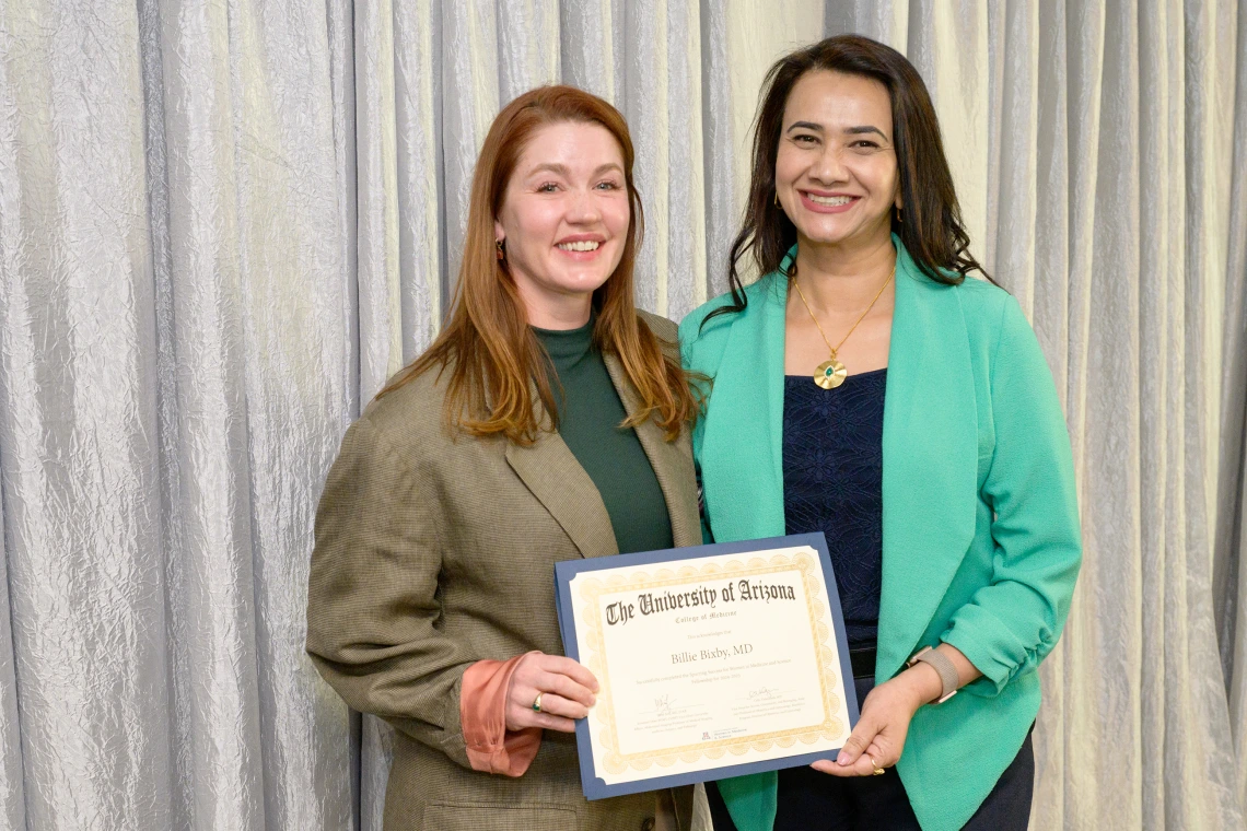 [DOM Interventional Pulmonology director Billie Bixby, MD, accepts her LAMS graduation certificate from COM-T Assistant Dean Hina Arif, MD.]