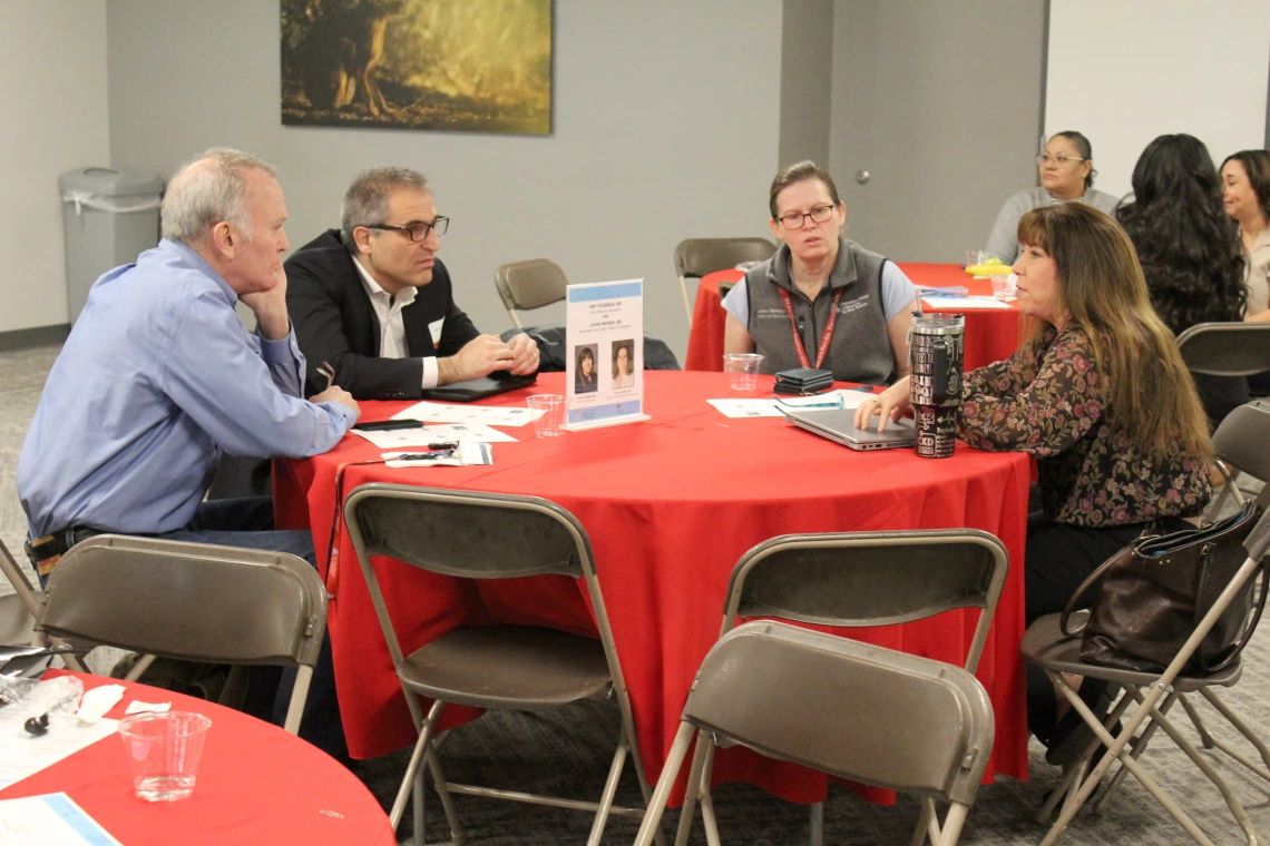 [Amy Sussman, MD (on right), and Laura Meinke, MD, DOM vice chair and associate vice chair of education, talk with Hossein Ardehali, MD, PhD, and Luke Szweda, PhD, two new Division of Cardiology faculty members.]