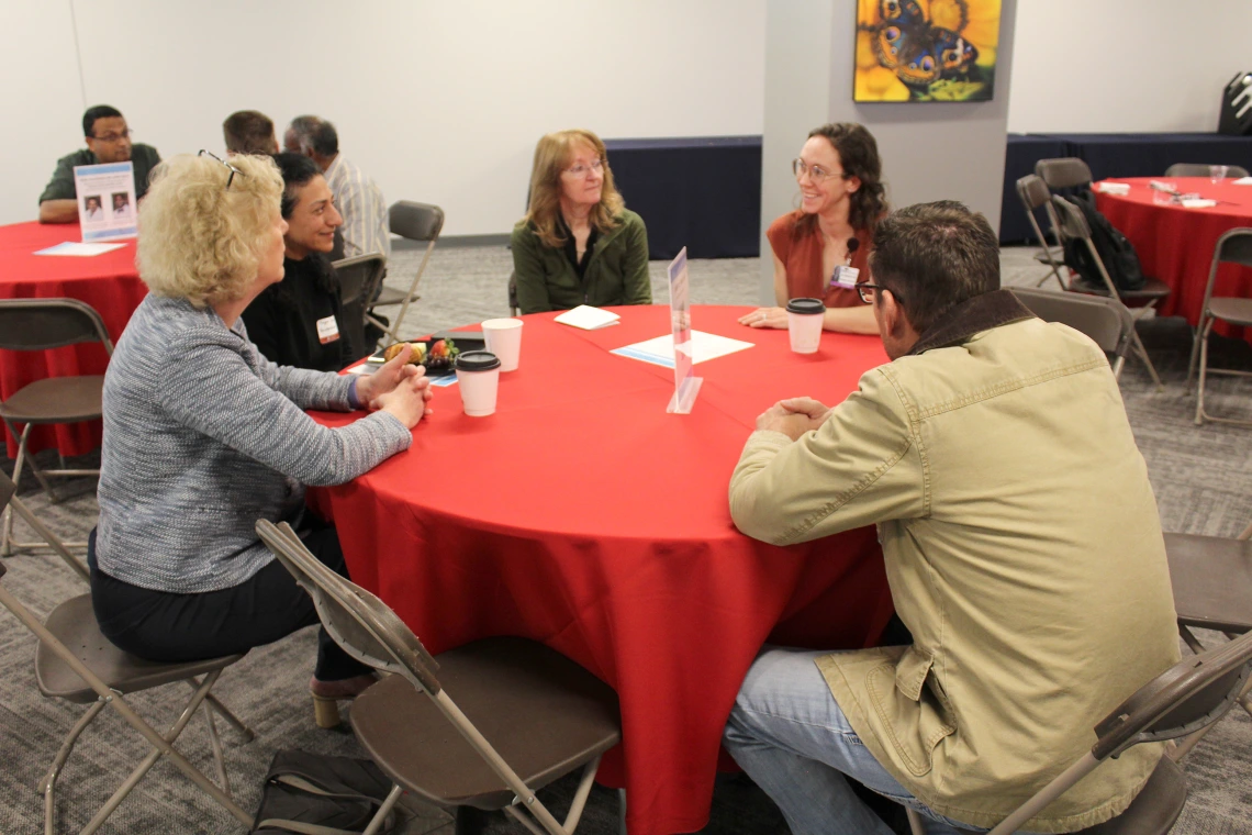 [From left, DOM vice chair of research Janet Funk, MD, and DOM biostatistician Maryam Emami, PhD, speaking with Susan Favour, MD,  Anna Morenz, MD, MPH –  with the Division of General Internal Medicine, Geriatrics & Palliative Medicine – and John Ireland, DO.]