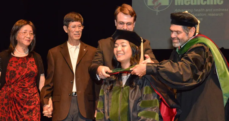 Elaine Situ-LaCasse, MD, receiving her medical degree at the Class of 2013 convocation ceremony