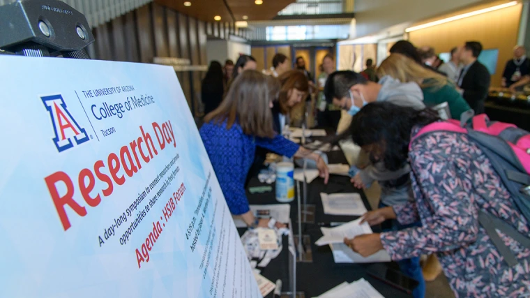[Attendees, presenters and panelists sign-in April 2 for the University of Arizona College of Medicine – Tucson Research Day 2025 activities at the HSIB Forum at the U of A Health Sciences Tucson campus.]