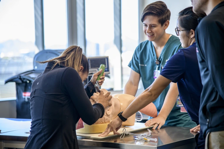 A student practices intubation on a mannequin
