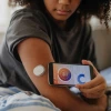 Person using a smart phone to obtain biometrics