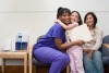 Doctor, child and mother happy after their pediatric appointment.